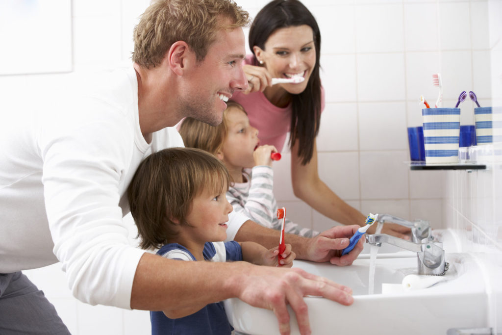 42254324 - family in bathroom brushing teeth